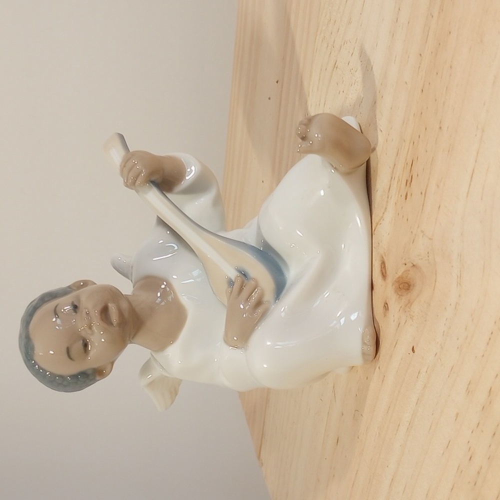 Lladro black angel boy playing lute or guitar